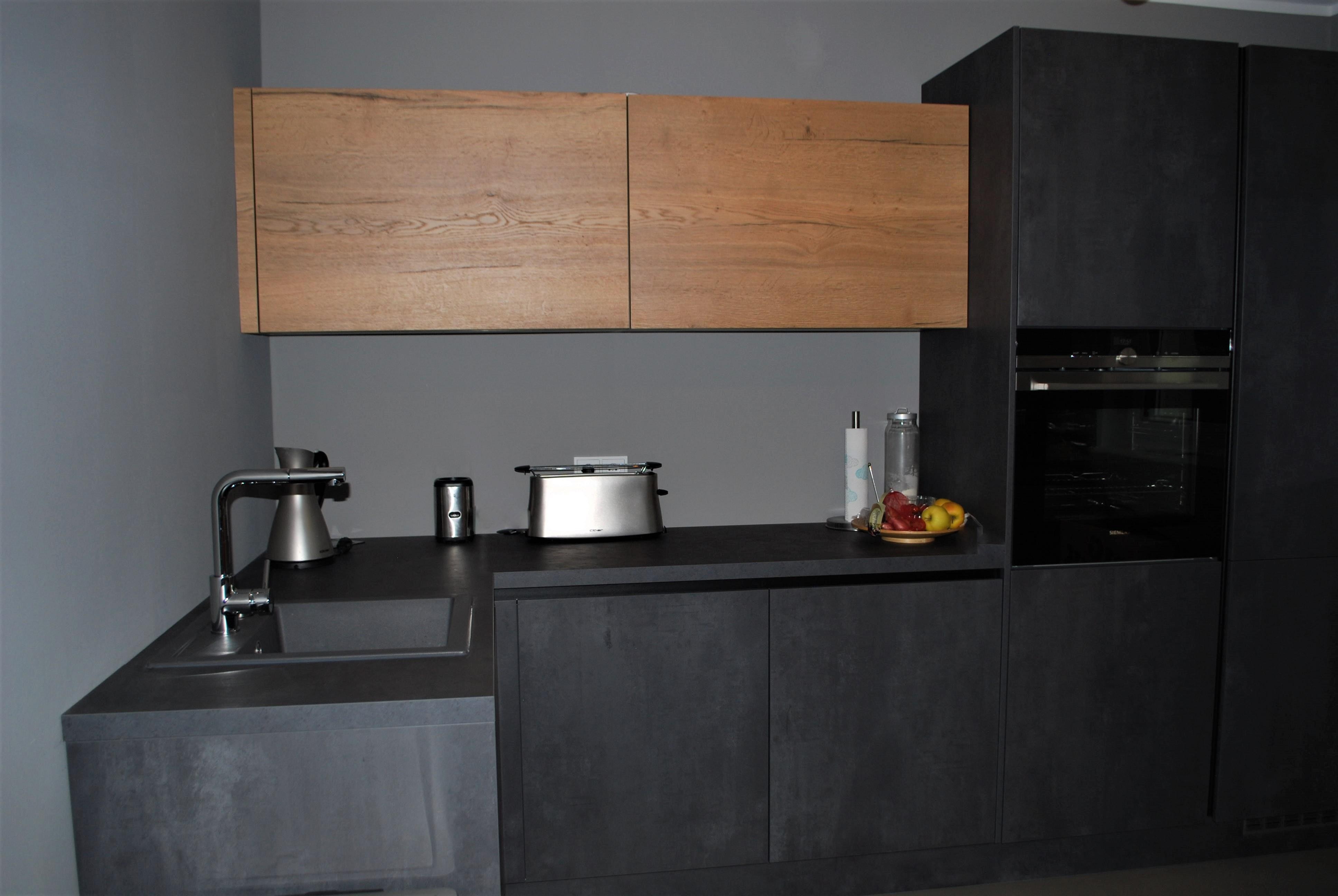 Kleine L-Küche in dunkler Betonoptik mit 2 Hängeschränken im Holzdekor