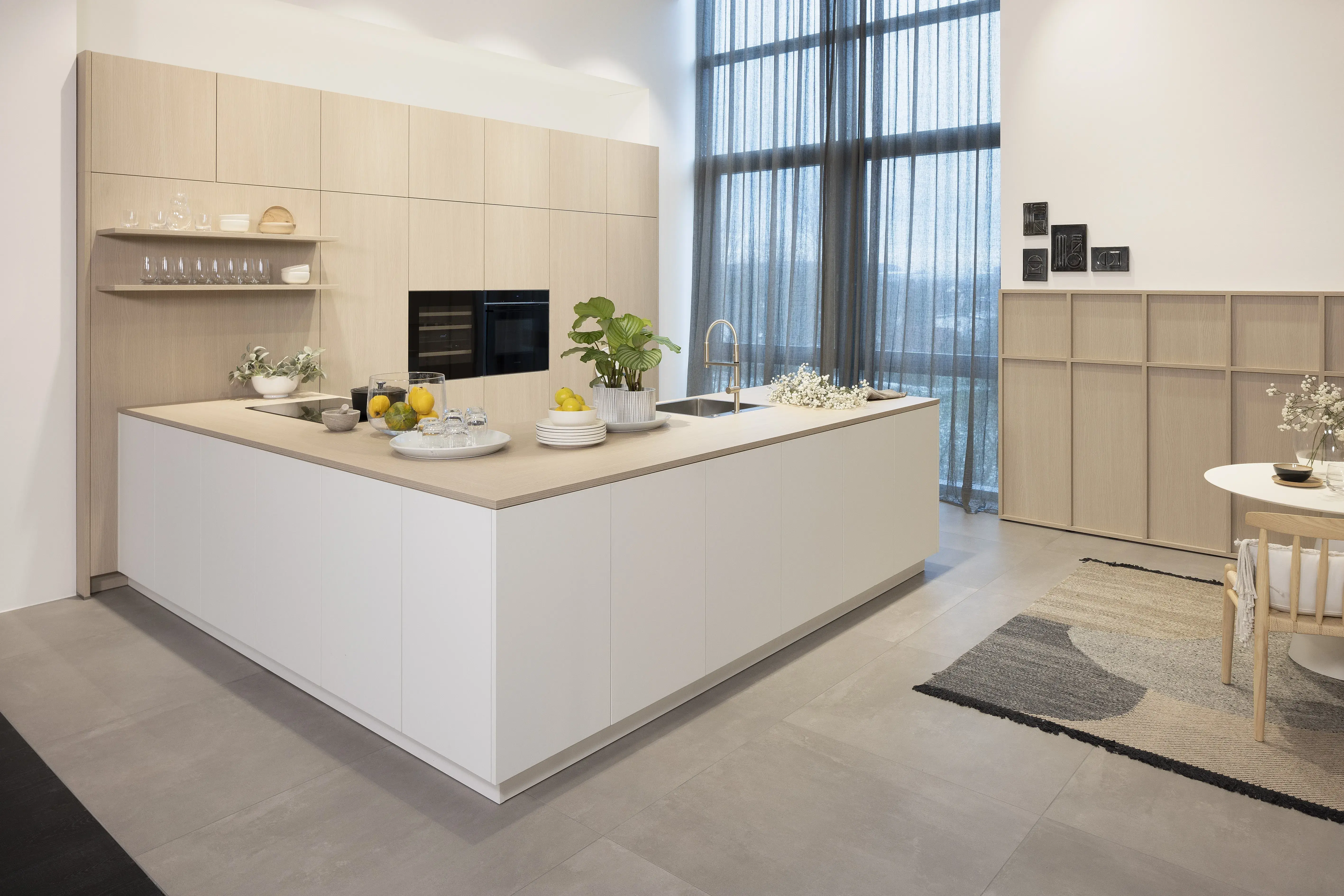 APL: Sandesche 25 mm Front: PLUS Weiß softmatt Front: neoLEAF Sandesche Korpus: Weiß Griff: PTO Geräte: Siemens, Kochfeld mit Abzug elica Armatur: Nobili Spüle: Reginox    Features: Skandinavisches Design, kompakte Wandlösung, Designgriff Weiß matt, Spüle flachbündig eingebaut, große L-Theke mit durchgängigem 60er-Raster, Wandkassetten in Frontmaterial Sandesche